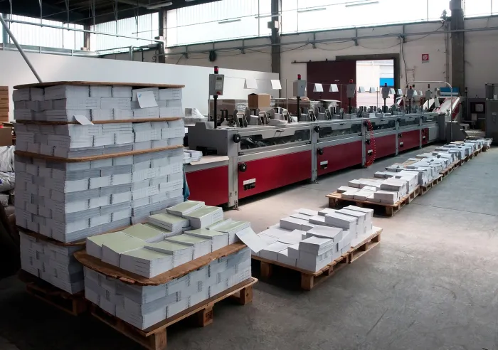 Stacks of page blocks in a print facility ready to be Perfect Bound