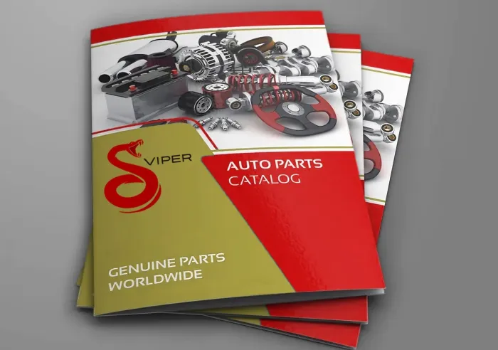 Stack of red and gold auto part catalogs with images of car parts on the cover.