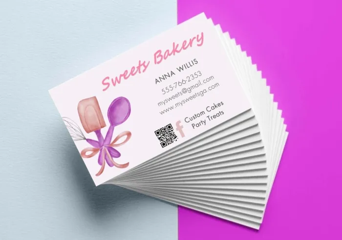 A stack of Business Cards for a bakery featuring contact information and a QR code