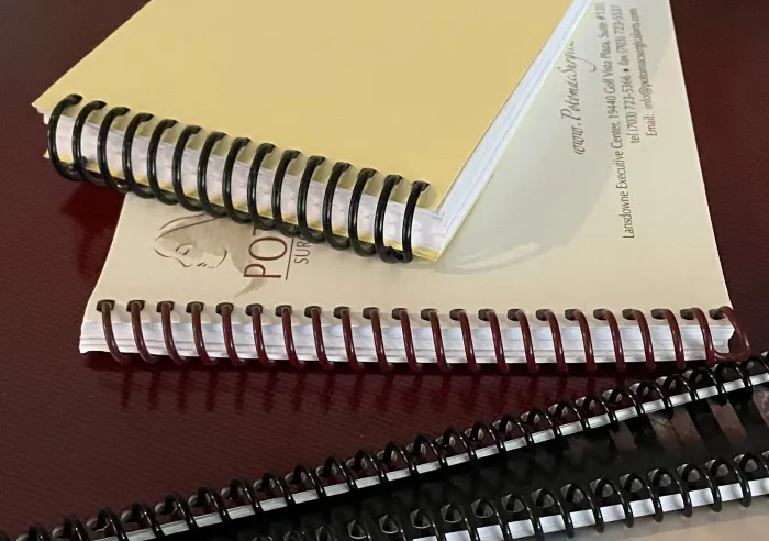 Four Spiral Bound books in a stack