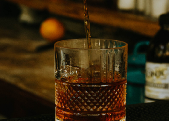 a glass of liquid with a straw