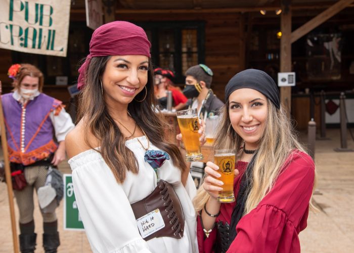 two women holding glasses of beer