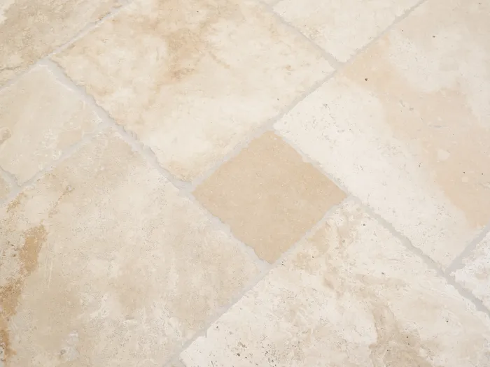 a close-up of a stone tile floor after being cleaned by Zerorez with beautiful clean grout lines