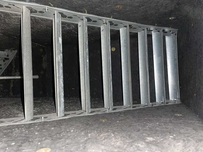 Inside of an HVAC system with metal dividers, free of dirt and debris after Zerorez cleaned it