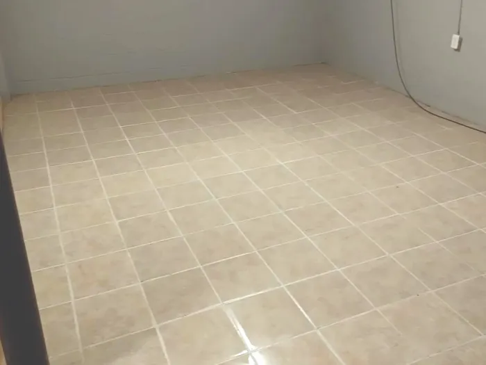 a room with a tile floor after being professionally cleaned by Zerorez for pristine white grout lines and a Residue Free® tile floor