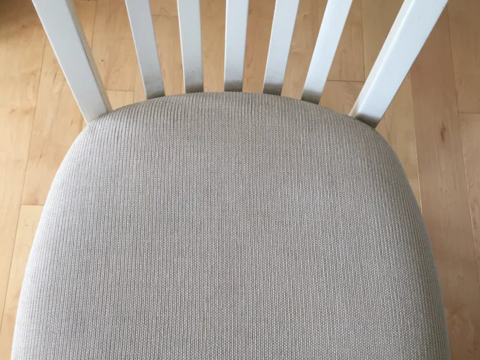 Grey dining room chair seat cushion after brown stains were removed by Zerorez upholstery cleaning services