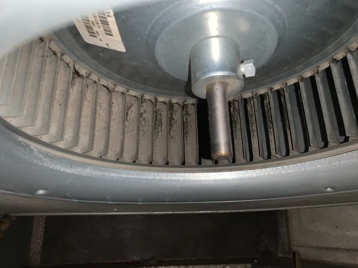 a close-up of an HVAC blower, with dust stuck to the blades