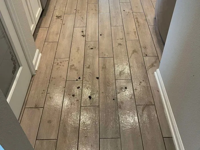 a wooden floor in a kitchen with dirty spots