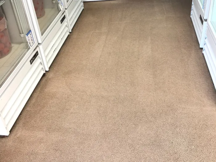 a clean carpet in a room with shelves and boxes