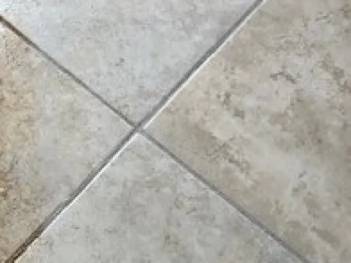 close up of the intersection of four floor tiles after being professionally cleaned