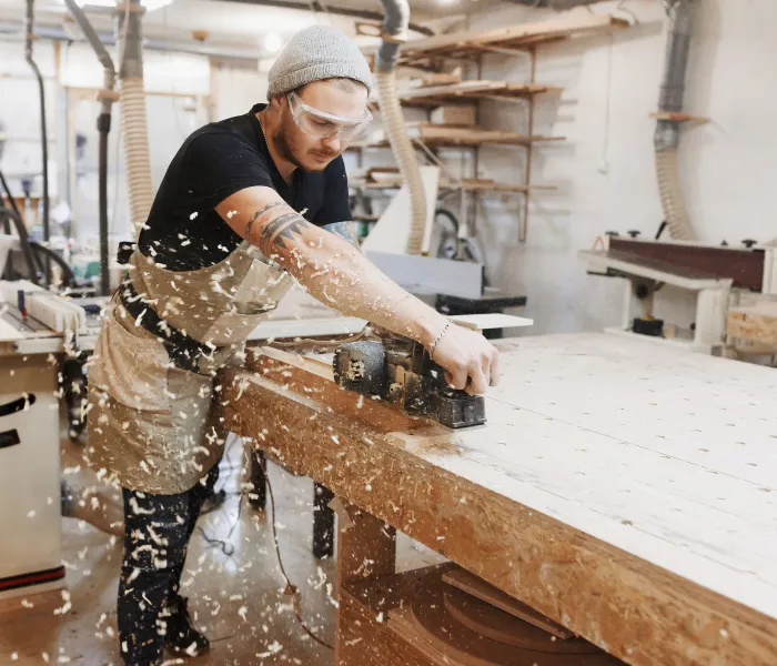 a man working on a piece of wood