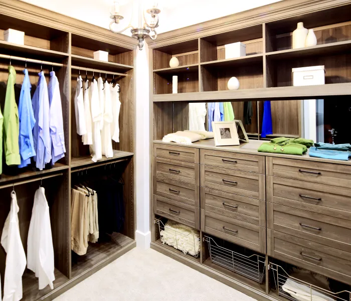 a closet with clothes and a mirror