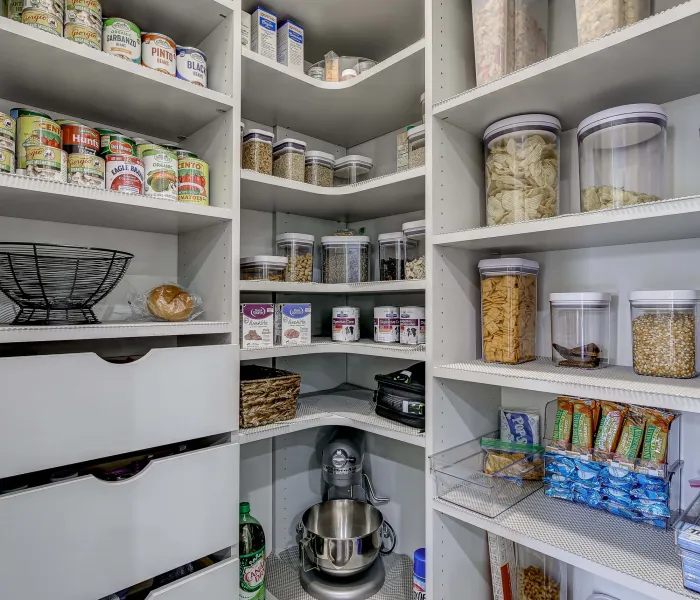 a kitchen with shelves full of food