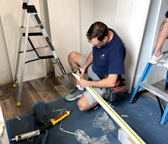 a man painting a blue canvas