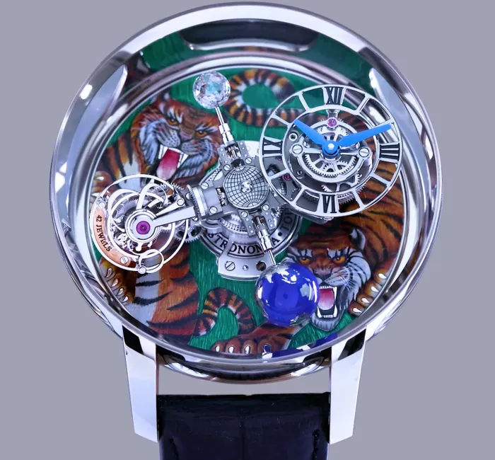 a silver watch with a blue globe