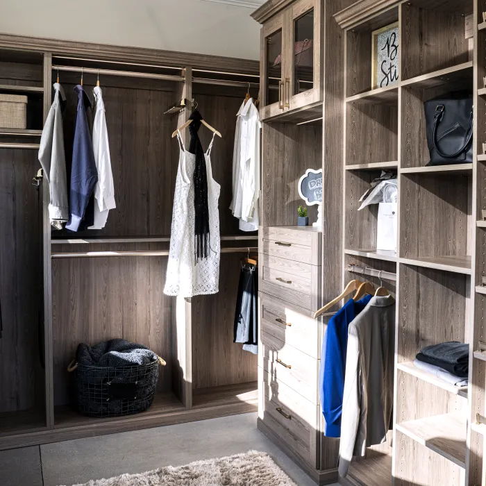 a closet with clothes and shoes