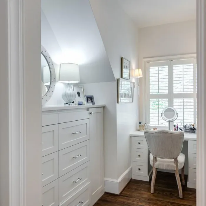 a white room with a chair and a sink