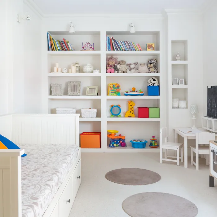 a room with a bed and shelves