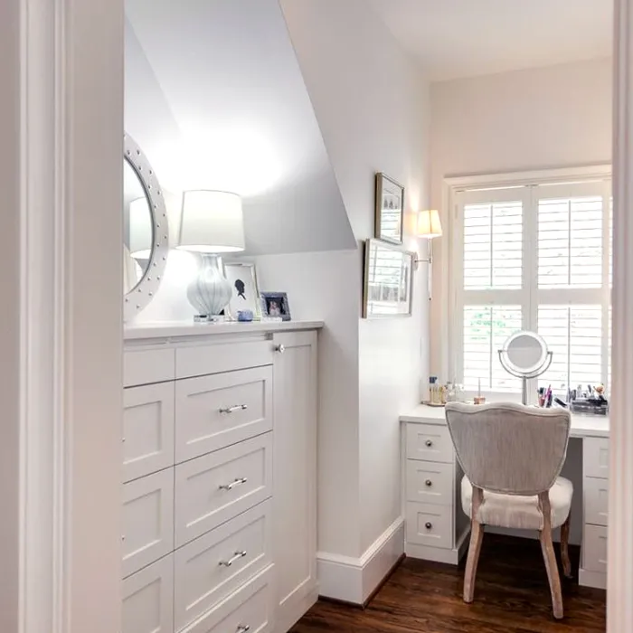 a white kitchen with a white cabinet