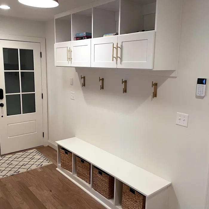 a mudroom with white cabinets