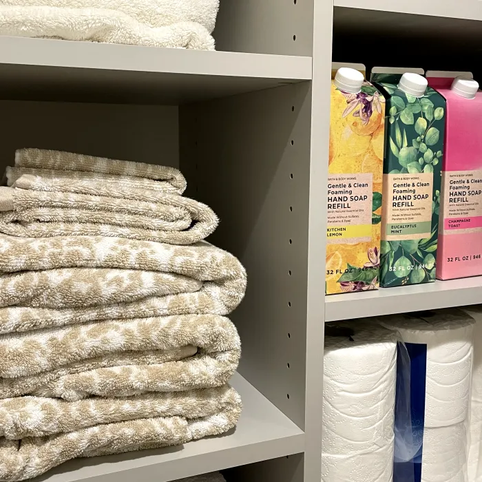 a shelf with towels and other objects on it