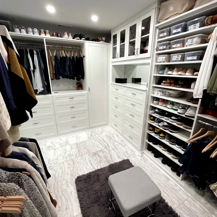 a room with a white cabinet and white cabinets