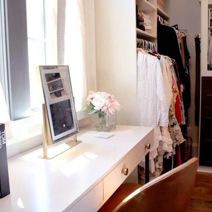 a white counter with a vase of flowers on it