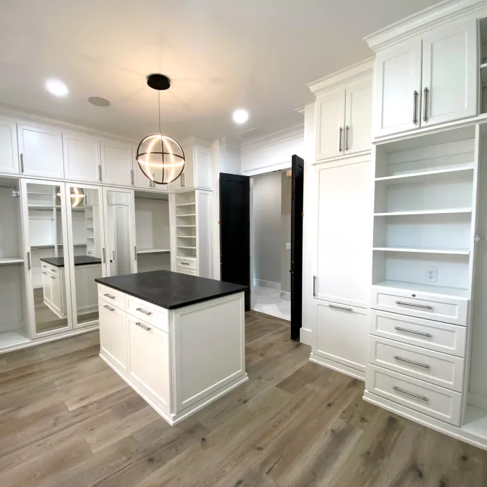 a kitchen with white cabinets