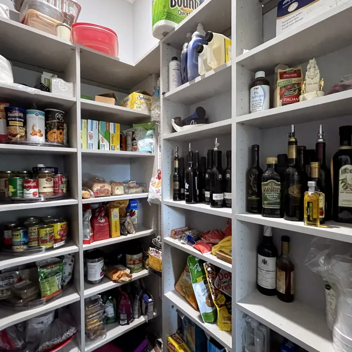 a custom designed pantry full of food and appliances