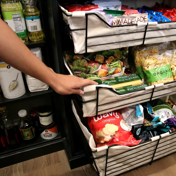 a person pushing a shopping cart full of food