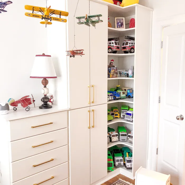 a white closet with a stuffed animal on top