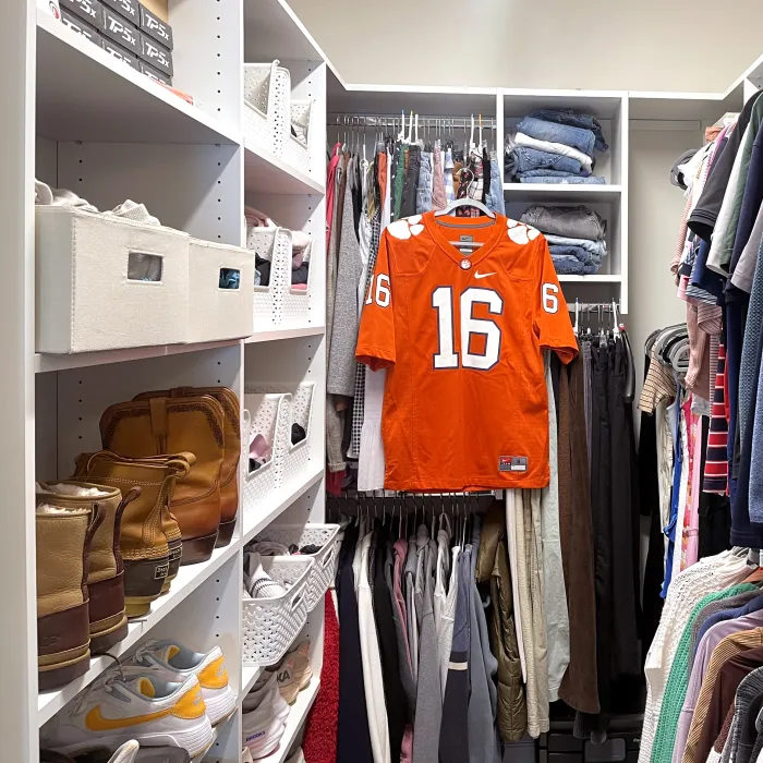 a custom designed closet full of clothes including a clemson university football jersey