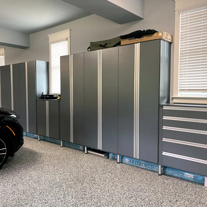 a room with a car and a large metal cabinet