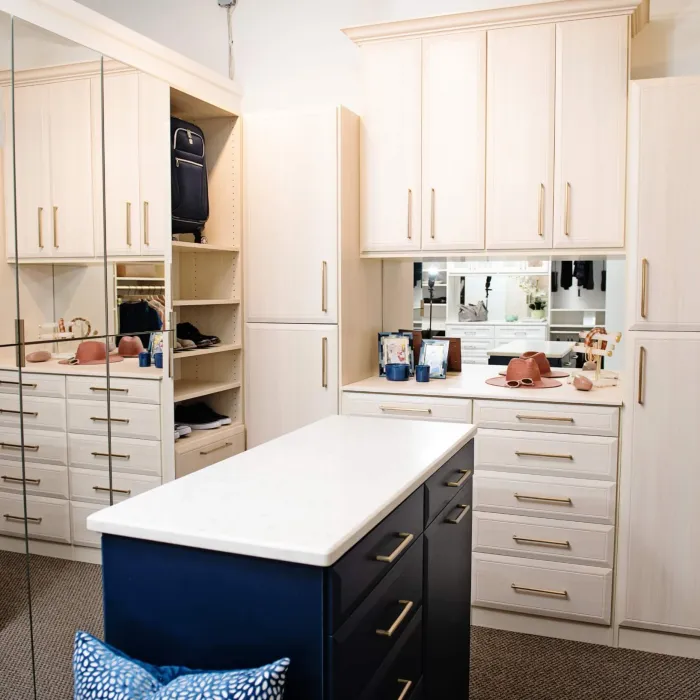 Stylish, organized walk-in closet featuring storage options and a central island for easy access.