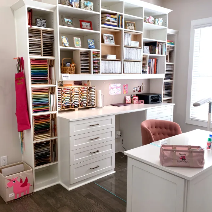 a room with a shelf full of books and a chair