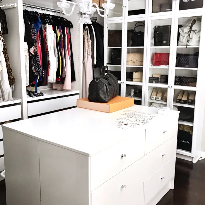 a white cabinet with a purse on top of it