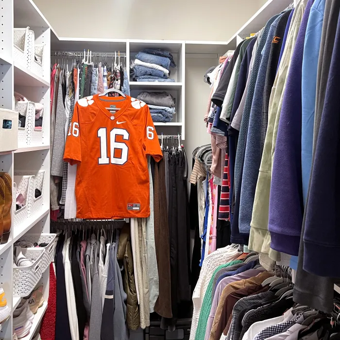 a custom closet full of clothes, golf gear, and Clemson University apparel