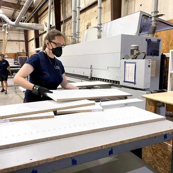 a man wearing a mask working on a machine