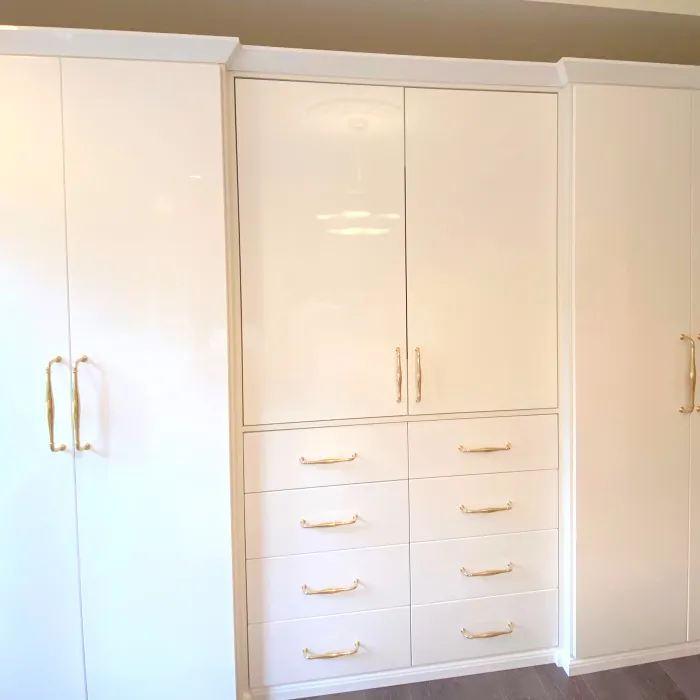 a white cabinet with drawers