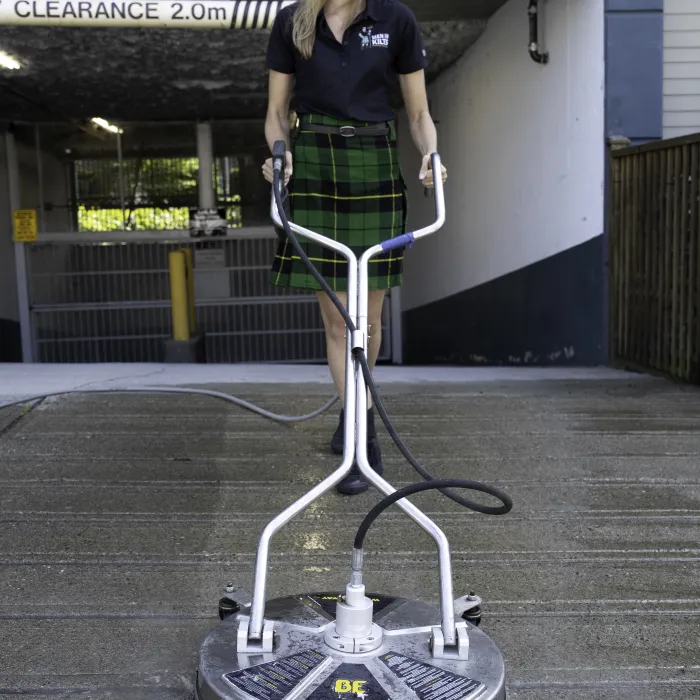 a woman cleaning a parking garage