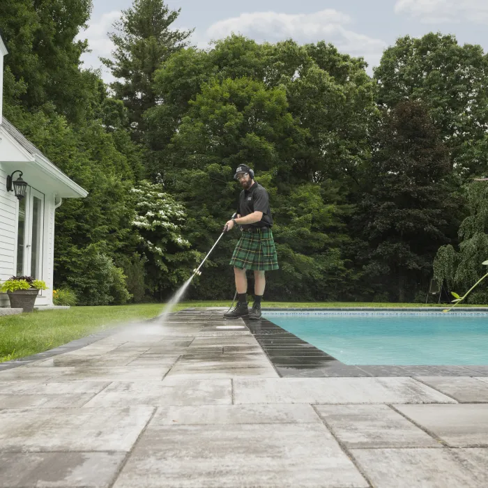 a person standing next to a pool