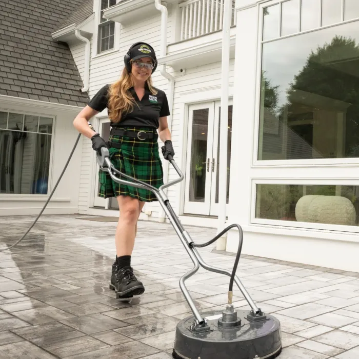 a woman in a kilt standing next to a man in a kilt and a kilt