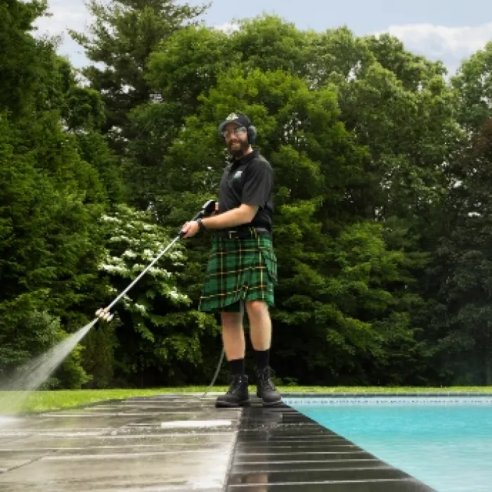 a man wearing a kilt and holding a fishing pole