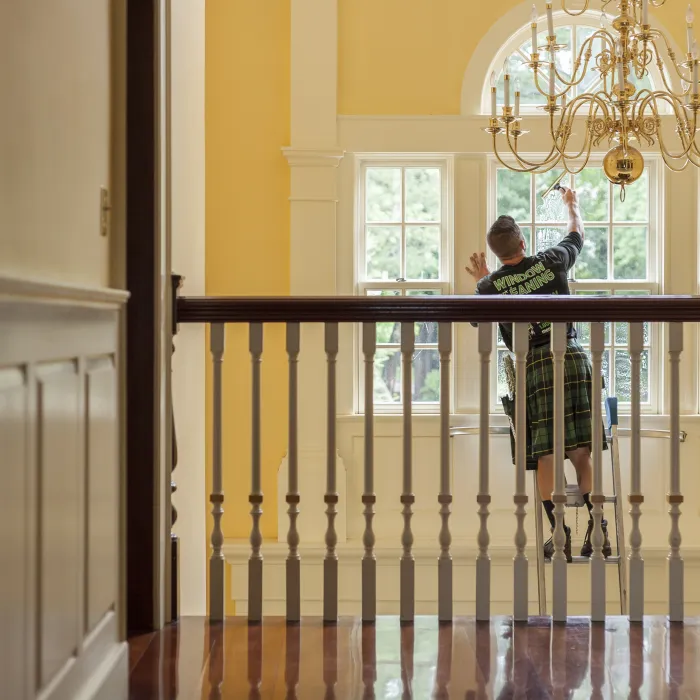 a man cleaning an interior window