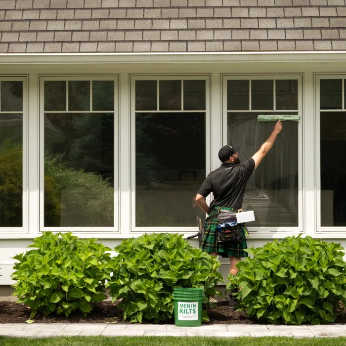 a man standing outside a house