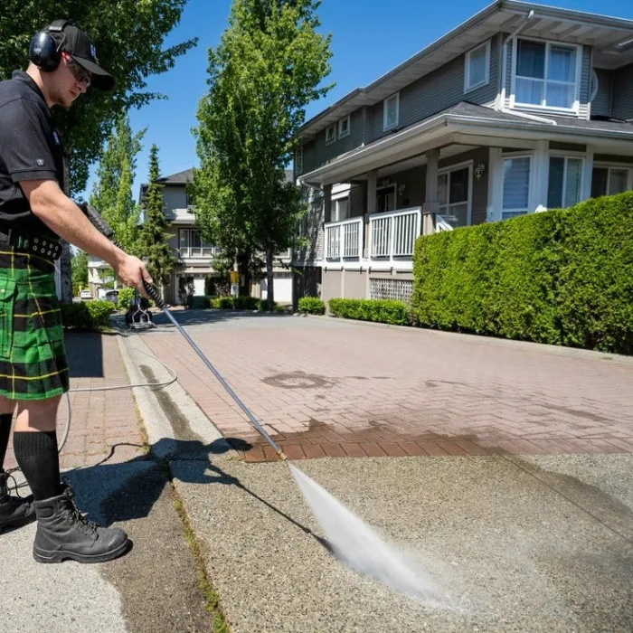 a man using a pressure washer