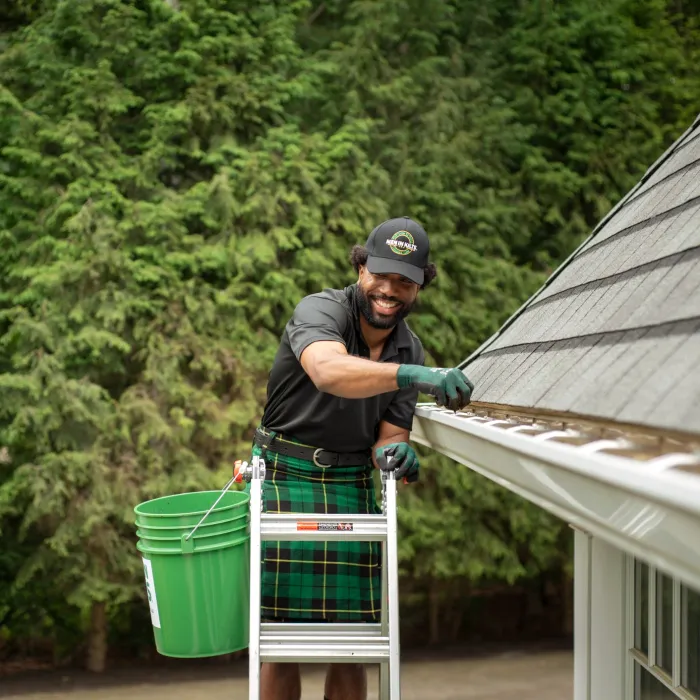 a person holding a green bucket