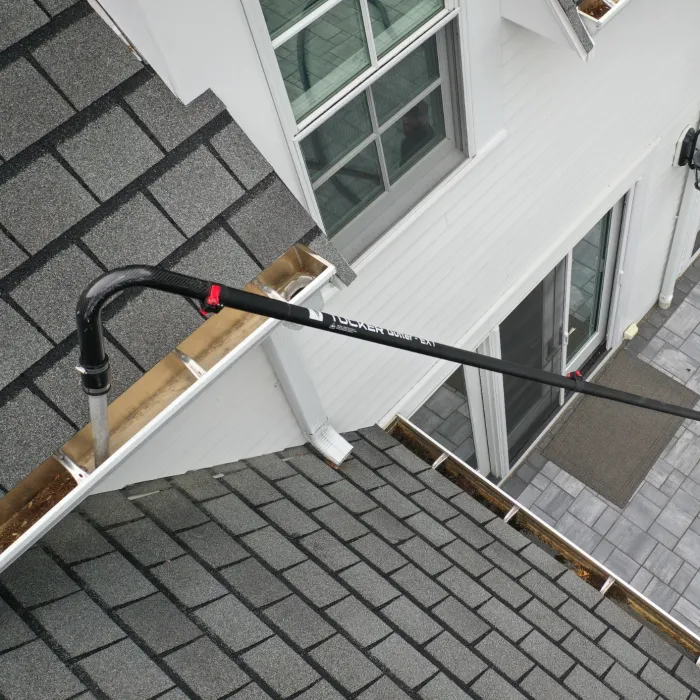 a person cleaning gutters