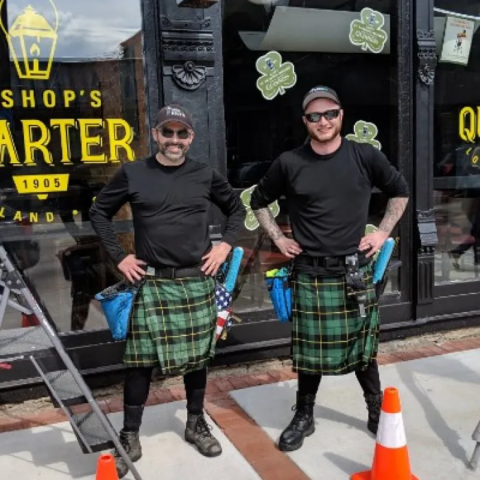 two men wearing kilts