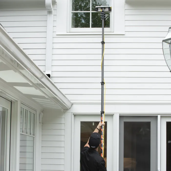 a person holding a light pole